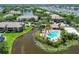 A bird's eye view showcasing a pool, spa, and recreational area nestled beside a tranquil pond in a community at 10265 Gandy N Blvd # 1004, St Petersburg, FL 33702