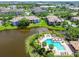 A scenic aerial view of condo buildings, the community pool, and a lovely pond, offering a tranquil setting at 10265 Gandy N Blvd # 1004, St Petersburg, FL 33702