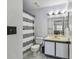 Bathroom with a vanity, toilet, mirror, and shower with gray and white curtain at 10265 Gandy N Blvd # 1004, St Petersburg, FL 33702