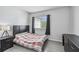 Bright bedroom with a bed, bedside table, dark curtains and wood-look flooring at 10265 Gandy N Blvd # 1004, St Petersburg, FL 33702