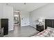 Bright bedroom showing wood-look floors, bed, and an open bathroom at 10265 Gandy N Blvd # 1004, St Petersburg, FL 33702