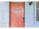 Condo entrance featuring a bright orange door with updated hardware, enhancing its curb appeal at 10265 Gandy N Blvd # 1004, St Petersburg, FL 33702