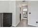 Hallway with wood floors leading to a bathroom and other rooms, offering ample storage with a black dresser at 10265 Gandy N Blvd # 1004, St Petersburg, FL 33702