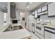 Efficient kitchen features white appliances, white cabinets, with updated flooring at 10265 Gandy N Blvd # 1004, St Petersburg, FL 33702