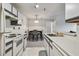 Efficient kitchen features white appliances and a dining area adjacent at 10265 Gandy N Blvd # 1004, St Petersburg, FL 33702