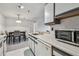Efficient kitchen features white appliances and a dining area adjacent at 10265 Gandy N Blvd # 1004, St Petersburg, FL 33702