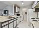 Efficient kitchen features white appliances, white cabinets, and a laundry room right off the side at 10265 Gandy N Blvd # 1004, St Petersburg, FL 33702