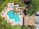 Overhead shot of a community pool, showing the ample seating, the hot tub, and tropical landscaping at 10265 Gandy N Blvd # 1004, St Petersburg, FL 33702