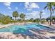 Outdoor community pool with palm trees and lounge chairs on a sunny day, a great place to relax at 10265 Gandy N Blvd # 1004, St Petersburg, FL 33702