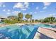 Outdoor community pool with palm trees and lounge chairs on a sunny day, a great place to relax at 10265 Gandy N Blvd # 1004, St Petersburg, FL 33702