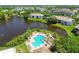 Aerial shot of a luxurious pool surrounded by lush landscaping and a serene pond, ideal for relaxation and recreation at 10265 Gandy N Blvd # 1004, St Petersburg, FL 33702