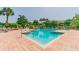 Inviting swimming pool with a waterfall and surrounding tropical landscaping and ample seating at 10265 Gandy N Blvd # 1004, St Petersburg, FL 33702