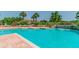 Refreshing community pool with waterfall feature, lounge chairs, and lush tropical landscaping at 10265 Gandy N Blvd # 1004, St Petersburg, FL 33702
