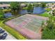 Aerial view of tennis courts showing a well-maintained area surrounded by lush greenery and mature trees at 10265 Gandy N Blvd # 1004, St Petersburg, FL 33702