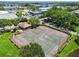 Aerial view of community tennis courts, surrounded by greenery and landscaping at 10265 Gandy N Blvd # 1004, St Petersburg, FL 33702