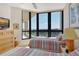 Bright bedroom featuring two beds, an ocean view, ceiling fan and balcony access at 1211 Gulf Of Mexico Dr # 704, Longboat Key, FL 34228