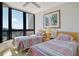 Bright bedroom with two beds, large windows with ocean views, and a ceiling fan at 1211 Gulf Of Mexico Dr # 704, Longboat Key, FL 34228