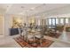 Elegant dining room with mirrored wall and seating for six, adjacent to the living area with ocean views at 1211 Gulf Of Mexico Dr # 704, Longboat Key, FL 34228