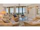 Bright living room with neutral decor, comfortable seating, and stunning ocean views from large windows at 1211 Gulf Of Mexico Dr # 704, Longboat Key, FL 34228