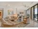 Open living room featuring neutral tones, plush seating, and access to a private balcony with ocean views at 1211 Gulf Of Mexico Dr # 704, Longboat Key, FL 34228
