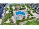 An aerial view of a pool and Jacuzzi surrounded by lush landscaping at 1211 Gulf Of Mexico Dr # 704, Longboat Key, FL 34228