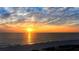 Beautiful sunset over the ocean with a sandy beach in the foreground at 1211 Gulf Of Mexico Dr # 704, Longboat Key, FL 34228