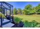 Expansive backyard with lush lawn, mature trees, and a screened lanai, ideal for outdoor living at 12710 Coastal Breeze Way, Bradenton, FL 34211