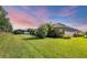 Expansive backyard featuring a lush lawn and tropical landscaping, perfect for outdoor activities at 12710 Coastal Breeze Way, Bradenton, FL 34211