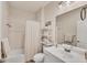 Bright bathroom with a shower-tub combo, single sink vanity, and open shelving at 12710 Coastal Breeze Way, Bradenton, FL 34211