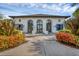 Exterior of clubhouse with archways, blue shutters, and well-maintained landscaping at 12710 Coastal Breeze Way, Bradenton, FL 34211