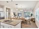 Open-concept kitchen flows into dining and living areas, with granite counters and stainless appliances at 12710 Coastal Breeze Way, Bradenton, FL 34211