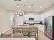 Kitchen features white cabinets, stainless appliances, granite counters, and bar stool seating at 12710 Coastal Breeze Way, Bradenton, FL 34211