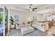 Open-concept living room with neutral walls, stylish furniture, and access to the lanai at 12710 Coastal Breeze Way, Bradenton, FL 34211