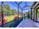 Charming screened-in lanai offering tranquil views of the backyard and lush greenery at 12710 Coastal Breeze Way, Bradenton, FL 34211