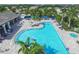 Aerial view of a large community pool with lounge chairs and clear blue water at 12710 Coastal Breeze Way, Bradenton, FL 34211