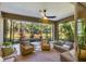 Inviting screened patio with outdoor seating area, ceiling fan, and views of the lush backyard at 12710 Coastal Breeze Way, Bradenton, FL 34211