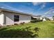 Well-maintained lawn and landscaped yard featuring white siding and several windows at 1315 Bottlebrush Dr, Bradenton, FL 34208