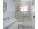This bathroom has a tiled floor and a shower and tub with a glass door and privacy glass at 1315 Bottlebrush Dr, Bradenton, FL 34208
