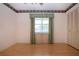 Cozy bedroom with wood floors, a window with curtains, and a closet at 1315 Bottlebrush Dr, Bradenton, FL 34208