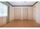 Bedroom featuring hard wood floors and plenty of storage with a large closet at 1315 Bottlebrush Dr, Bradenton, FL 34208