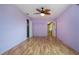 This lavender bedroom has hardwood floors, natural light, ceiling fan, and spacious closet at 1315 Bottlebrush Dr, Bradenton, FL 34208