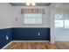 Dining room with wainscotting, lots of natural light, and hardwood floors at 1315 Bottlebrush Dr, Bradenton, FL 34208