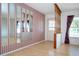 Inviting entryway features wood flooring, decorative mirrors, striped wallpaper, and stylish accents at 1315 Bottlebrush Dr, Bradenton, FL 34208