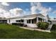 Home exterior features a well-maintained lawn, landscaping, and awnings over the windows at 1315 Bottlebrush Dr, Bradenton, FL 34208