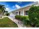Charming home with white trim, a lush green lawn, and well-maintained landscaping at 1315 Bottlebrush Dr, Bradenton, FL 34208