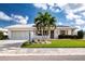 Lovely single Gathering home with solar panels, manicured landscaping, and a lush green lawn at 1315 Bottlebrush Dr, Bradenton, FL 34208