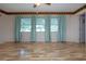 Spacious living room offers wood-look floors and a ceiling fan providing a comfortable place to relax at 1315 Bottlebrush Dr, Bradenton, FL 34208