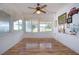 Inviting sunroom features wood-look flooring, fan and windows with valances filling the space with natural light at 1315 Bottlebrush Dr, Bradenton, FL 34208