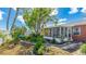 Beautiful backyard featuring mature trees, a stone walkway and a screened porch for enjoying the outdoors at 13492 Dibella Ave, Port Charlotte, FL 33981