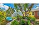 Charming backyard featuring a garden, mature shade trees, and outdoor furniture for relaxation and enjoyment at 13492 Dibella Ave, Port Charlotte, FL 33981